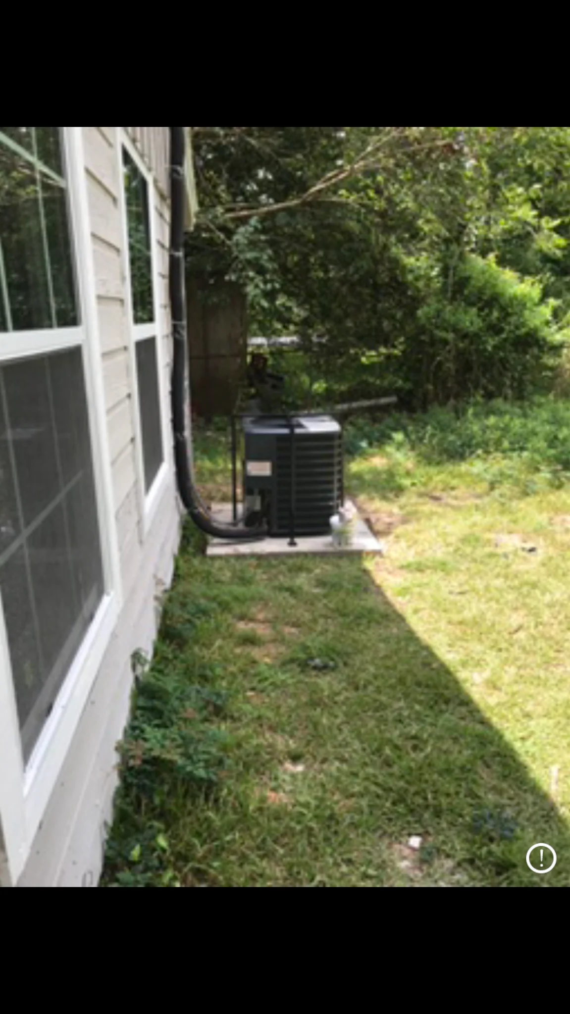AC condenser inside security cage — Pearland HVAC repair