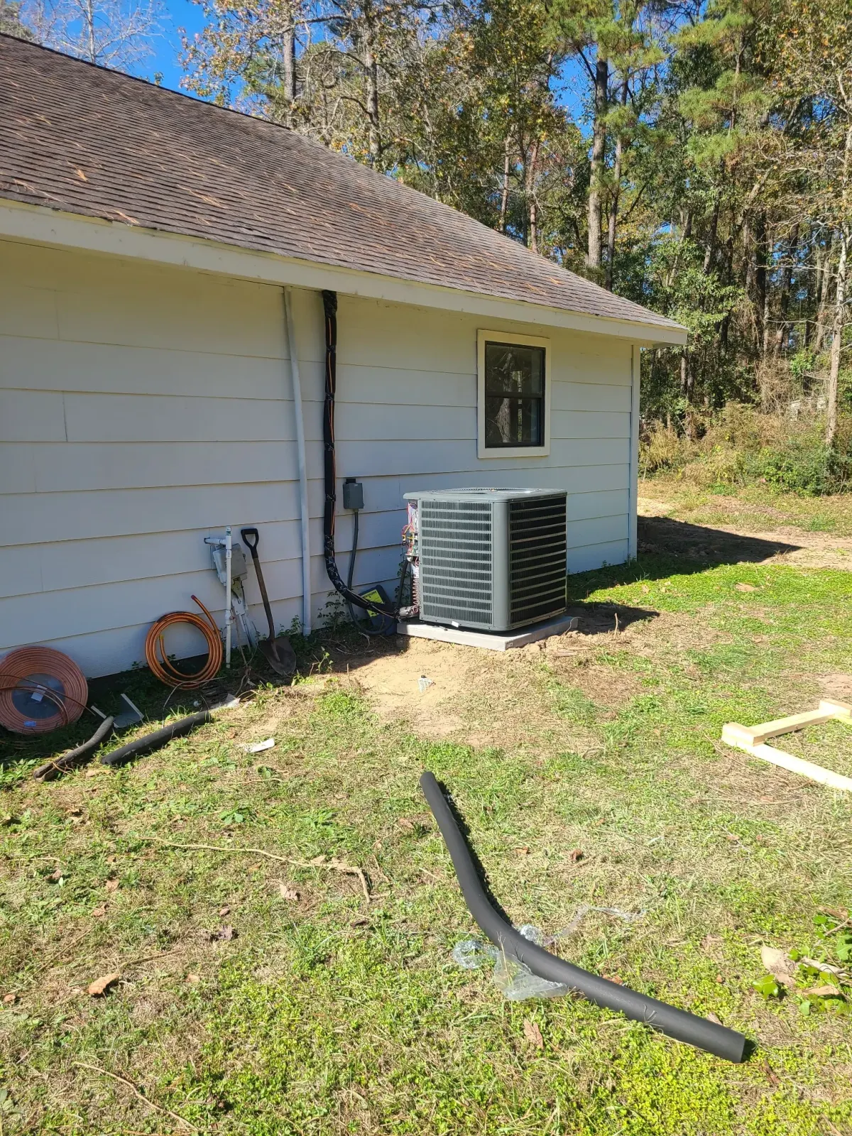 AC condenser installation in residential side yard — Pearland HVAC repair